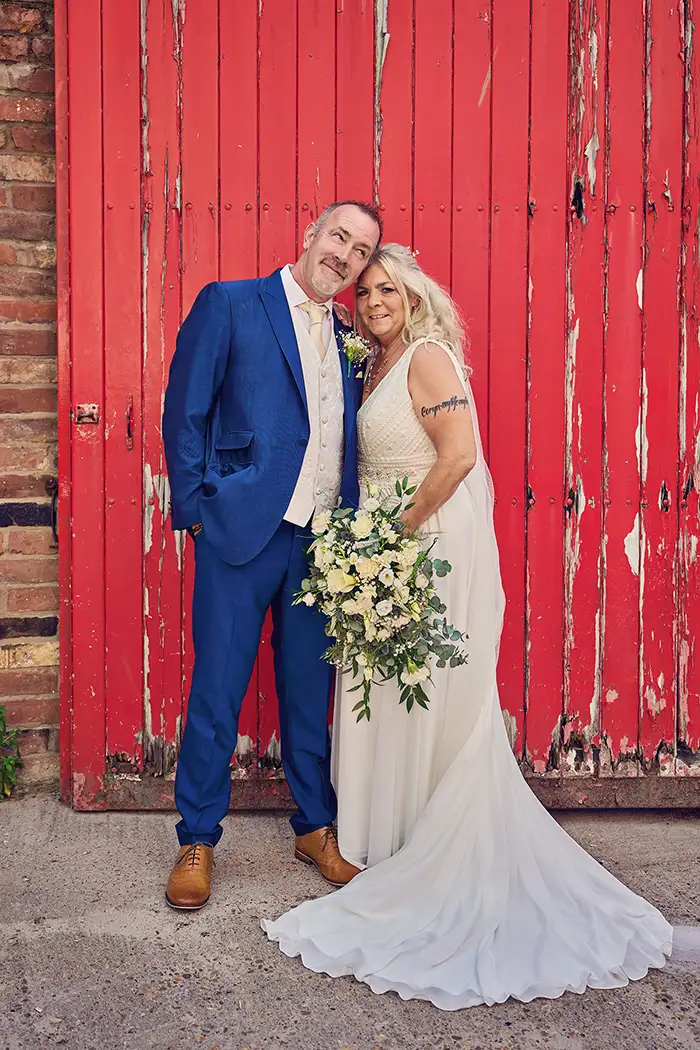 Bride and groom smiling together outside on their wedding day in Worcester